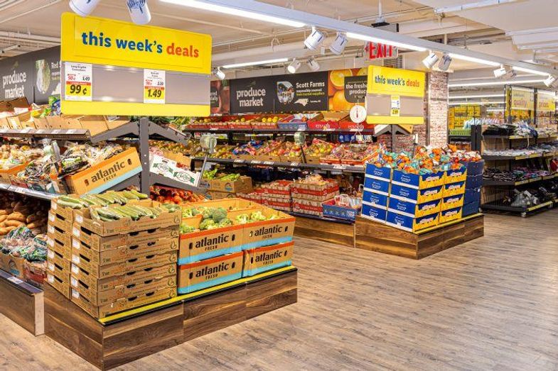 A picture containing text, indoor, truck, marketplace
Description automatically generated